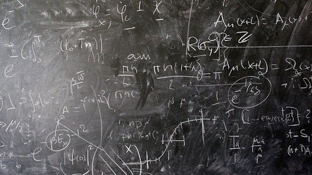 A detailed view of the blackboard with theoretical physics equations in chalk by Alberto Ramos, Theoretical Physics Fellow and visitor, Antonio Gonzalez-Arroyo from the Universidad Autonoma de Madrid.