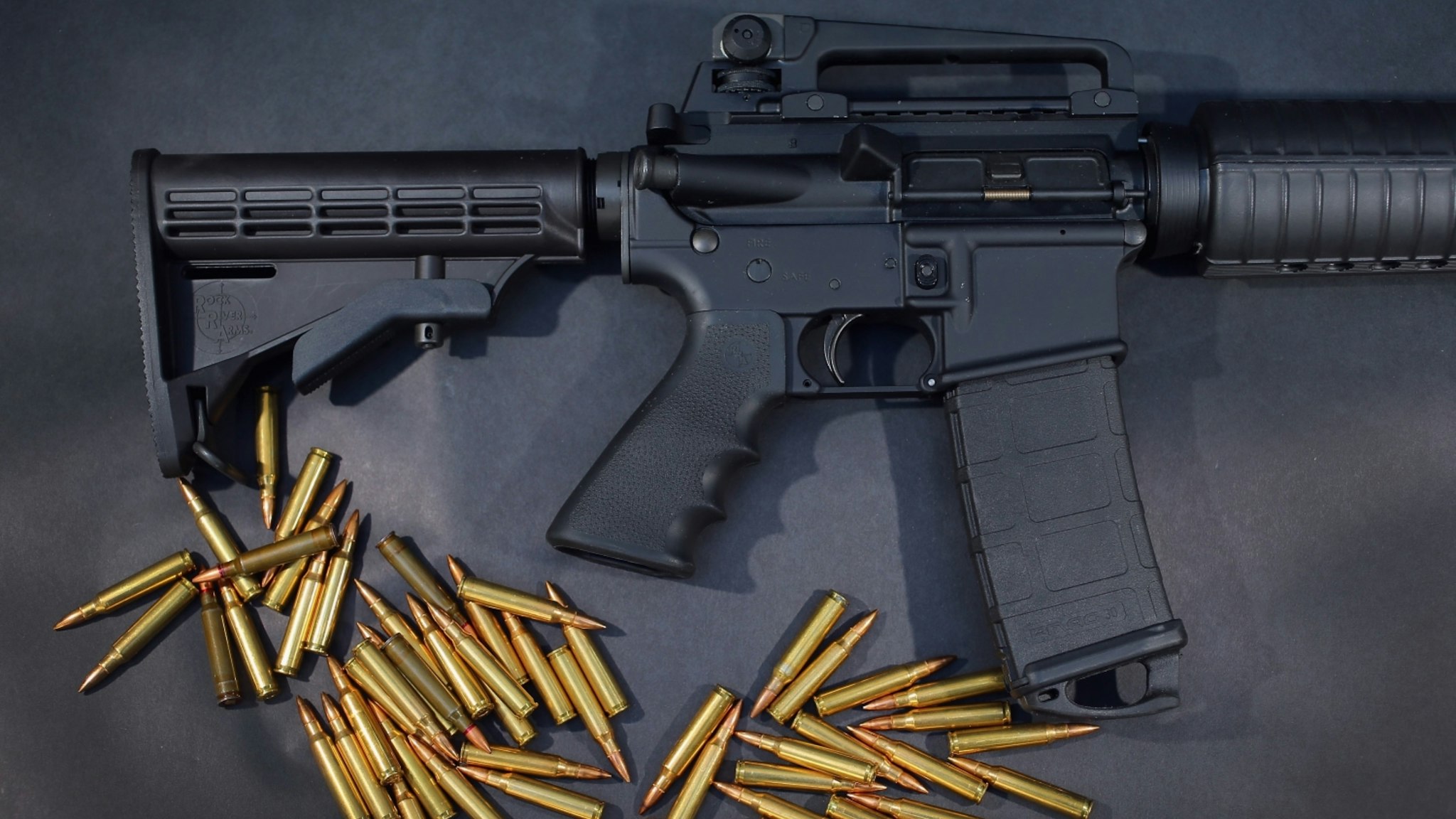 In this photo illustration, a Rock River Arms AR-15 rifle is seen with ammunition on December 18, 2012 in Miami, Florida.