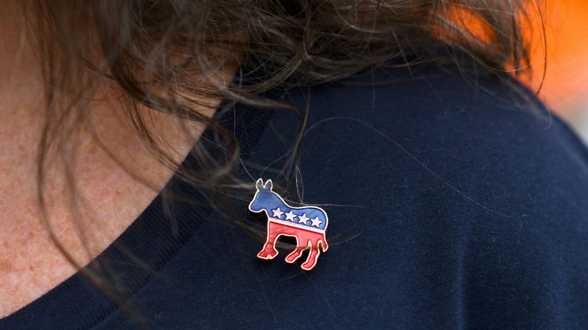 Donna Elms wears a Democrat donkey pin while lining up outside in advance of a campaign rally with former President Barack Obama, Pennsylvania Governor Tom Wolf, and Senator Bob Casey (D- PA) on September 21, 2018 in Philadelphia.