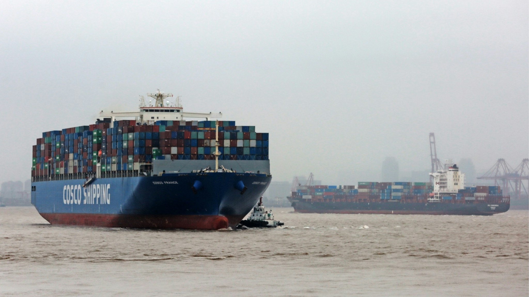 A Cosco France container ship berths with the help of tugboats at the Port of Ningbo-Zhoushan on September 1, 2019 in Zhoushan, Zhejiang Province of China.