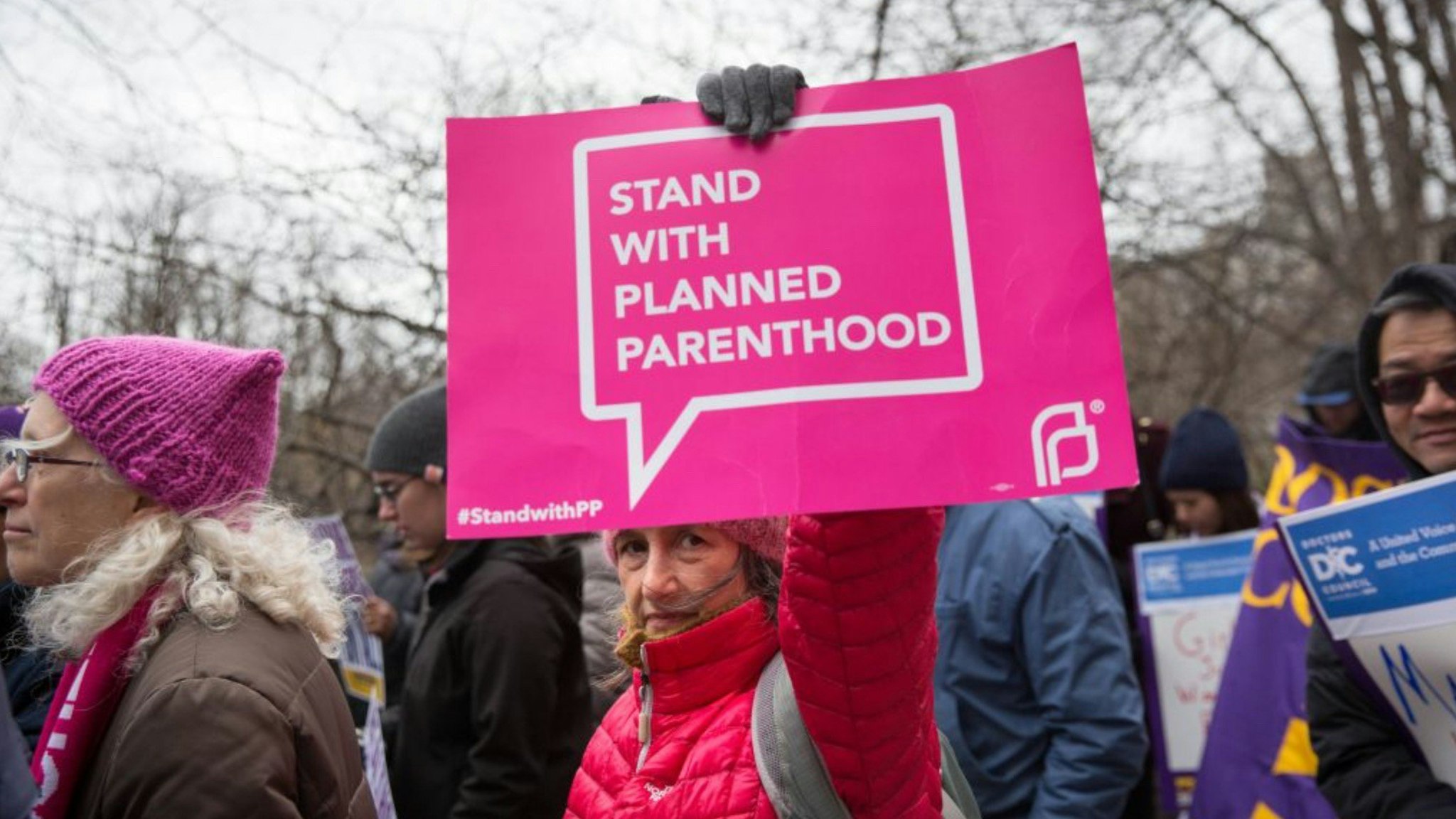 A health care activist lifts signage promoting Planned Parenthood during a rally as part of the national "March for Health" movement in front of Trump Tower on April 1, 2017 in New York City.