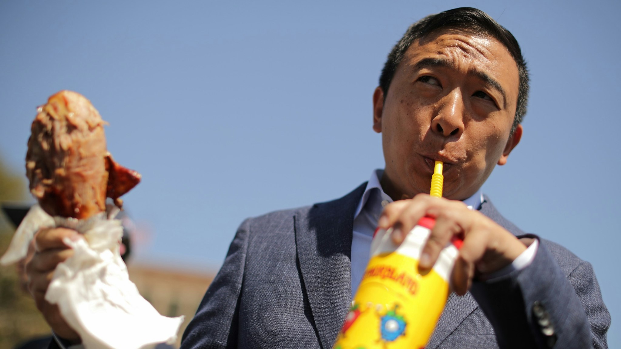 Democratic presidential candidate Andrew Yang eats a roasted turkey leg while visiting the Iowa State Fair August 09, 2019 in Des Moines, Iowa.