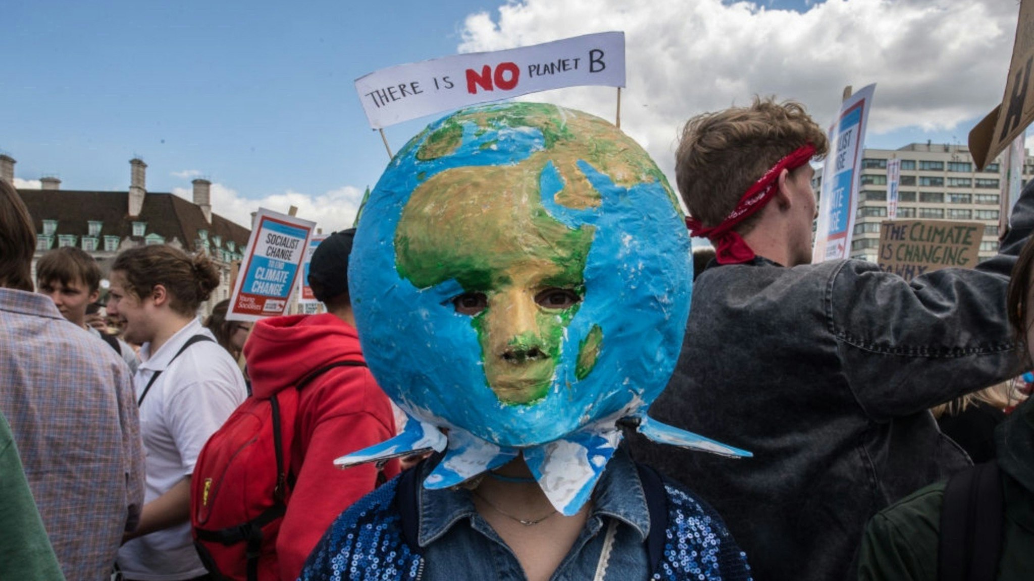 A striking school student with a planet mask on Westminster bridge on June 21, 2019 in London, England.