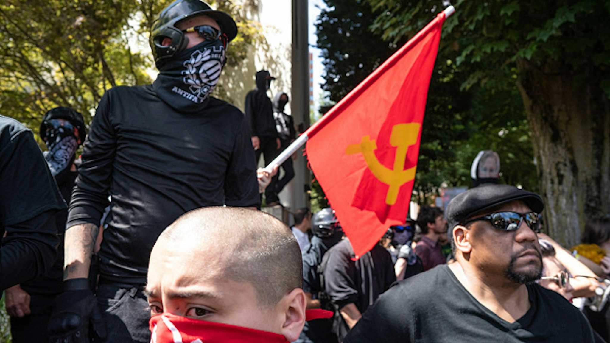 DOWNTOWN, PORTLAND, OREGON, UNITED STATES - 2018/08/04: Members of Antifa and other left-wing protesters watch far right protesters on the other side of the street during the Patriot Prayer Rally. The Proud Boys organized the Patriot Prayer Rally in Portland. The Proud Boys, a far right group supportive of President Donald Trump, used inflammatory language ahead of their rally, with some members promising violence. Counter-protesters led by Antifa confronted the participants of the Patriot Prayer Rally and clashed with police, leading to arrests and injuries.