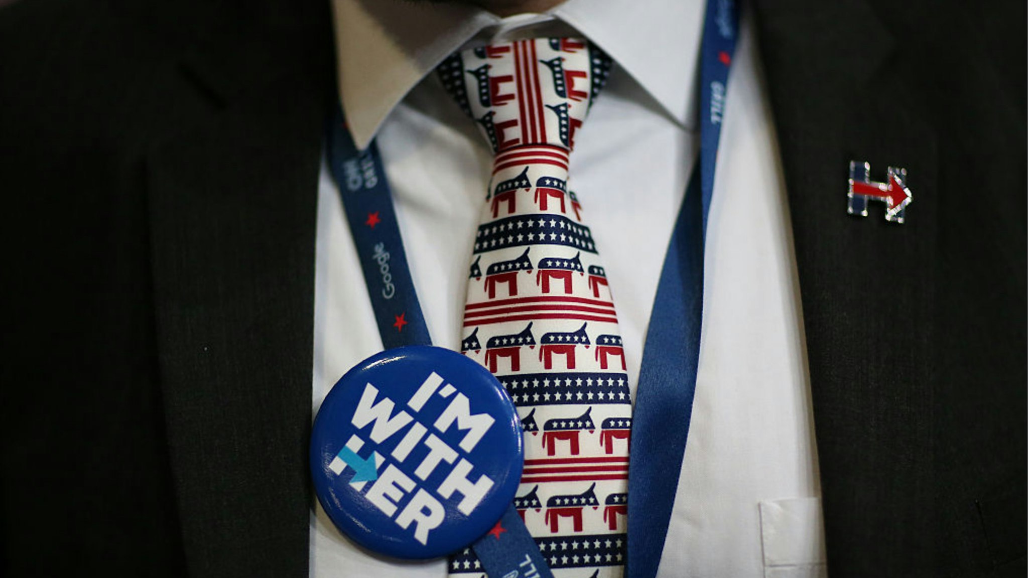 A delegate wears a Democratic party donkey themed tie and button reading "I'm With Her" during the Democratic National Convention (DNC) in Philadelphia, Pennsylvania, U.S., on Thursday, July 28, 2016.