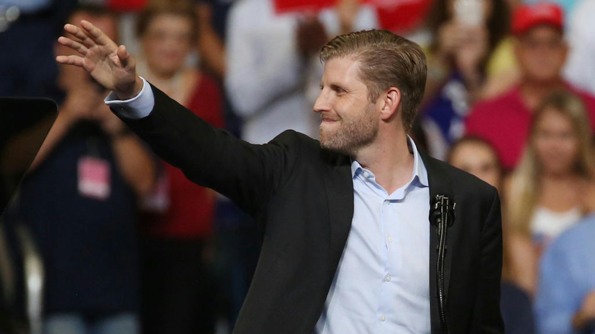 Eric Trump waves during the President Trump campaign rally at the Amway Center in downtown Orlando, Fla., on Tuesday, June 18, 2019.