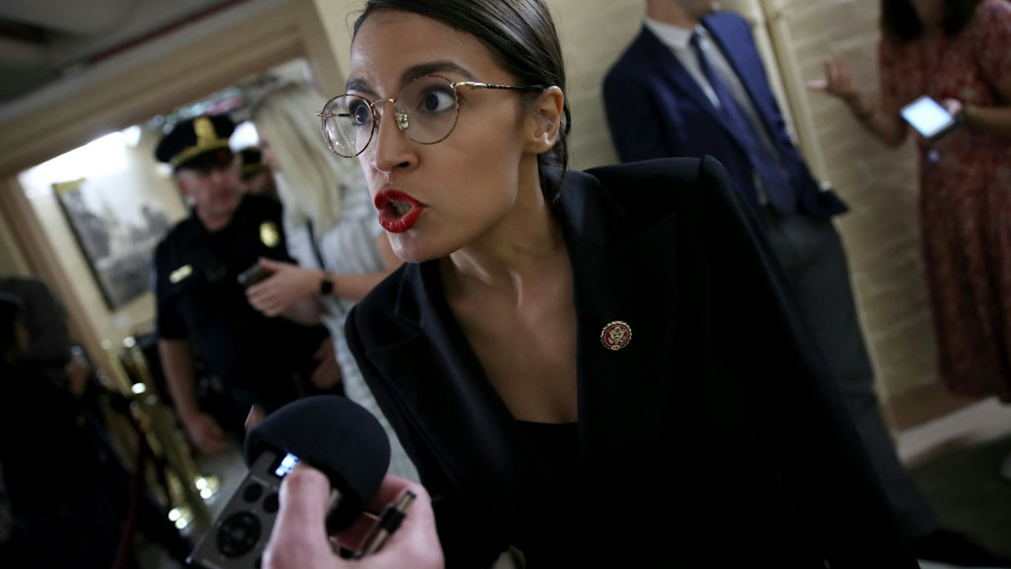 Rep. Alexandria Ocasio-Cortez (D-NY) answers questions from reporters while entering a House Democratic caucus meeting at the U.S. Capitol where formal impeachment proceedings against U.S. President Donald Trump were announced by Speaker of the House Nancy Pelosi September 24, 2019 in Washington, DC.