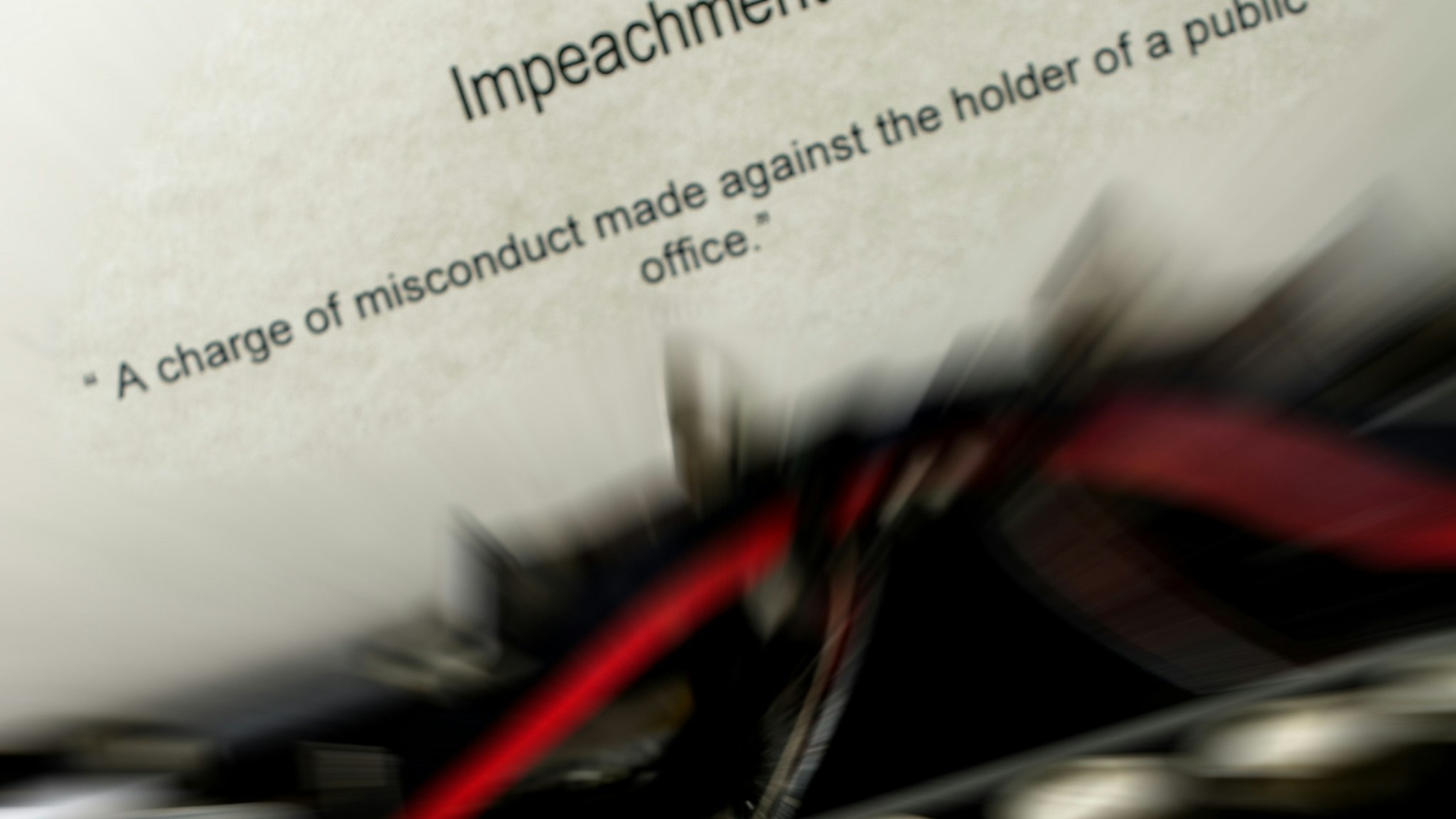 Current relevant word definitions typed on an antique typewriter. The definition for impeachment.