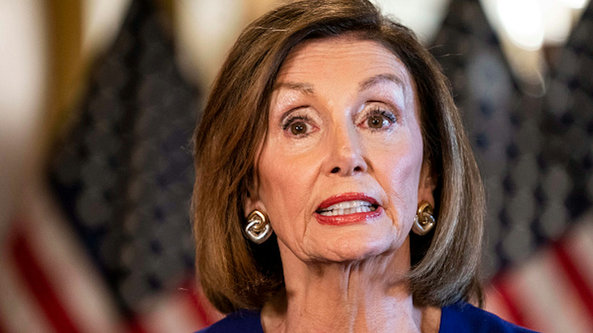 WASHINGTON, DC - September 24: From the Speaker's Balcony hallway, Speaker of the House Nancy Pelosi delivers a speech concerning a formal impeachment inquiry into President Donald Trump on Capitol Hill in Washington, DC on Tuesday September 24, 2019.