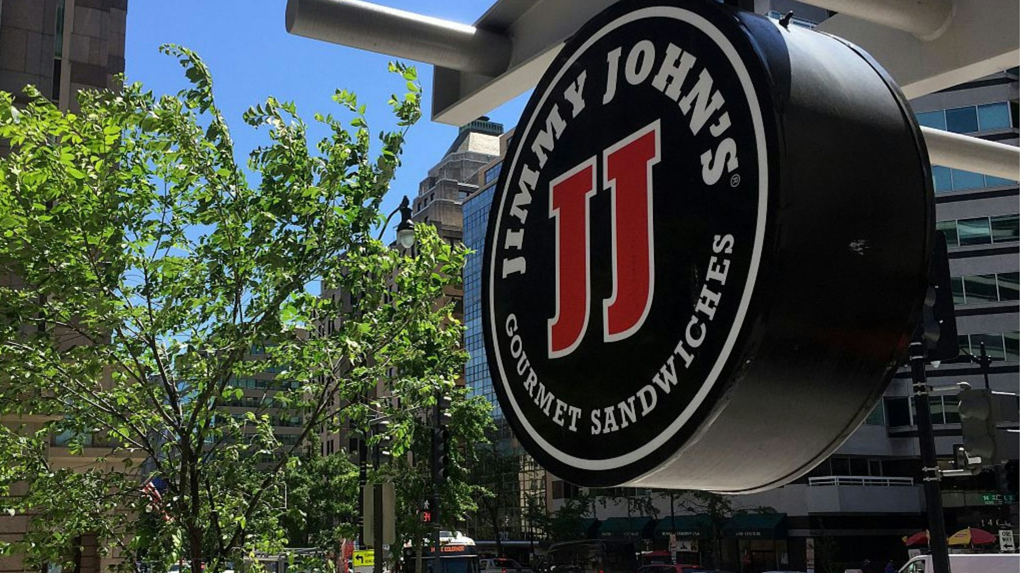 A logo of the sandwich restaurant chain, specializing in delivery Jimmy John's hangs outside one of their shops in downtown Washington, DC, June 9, 2016