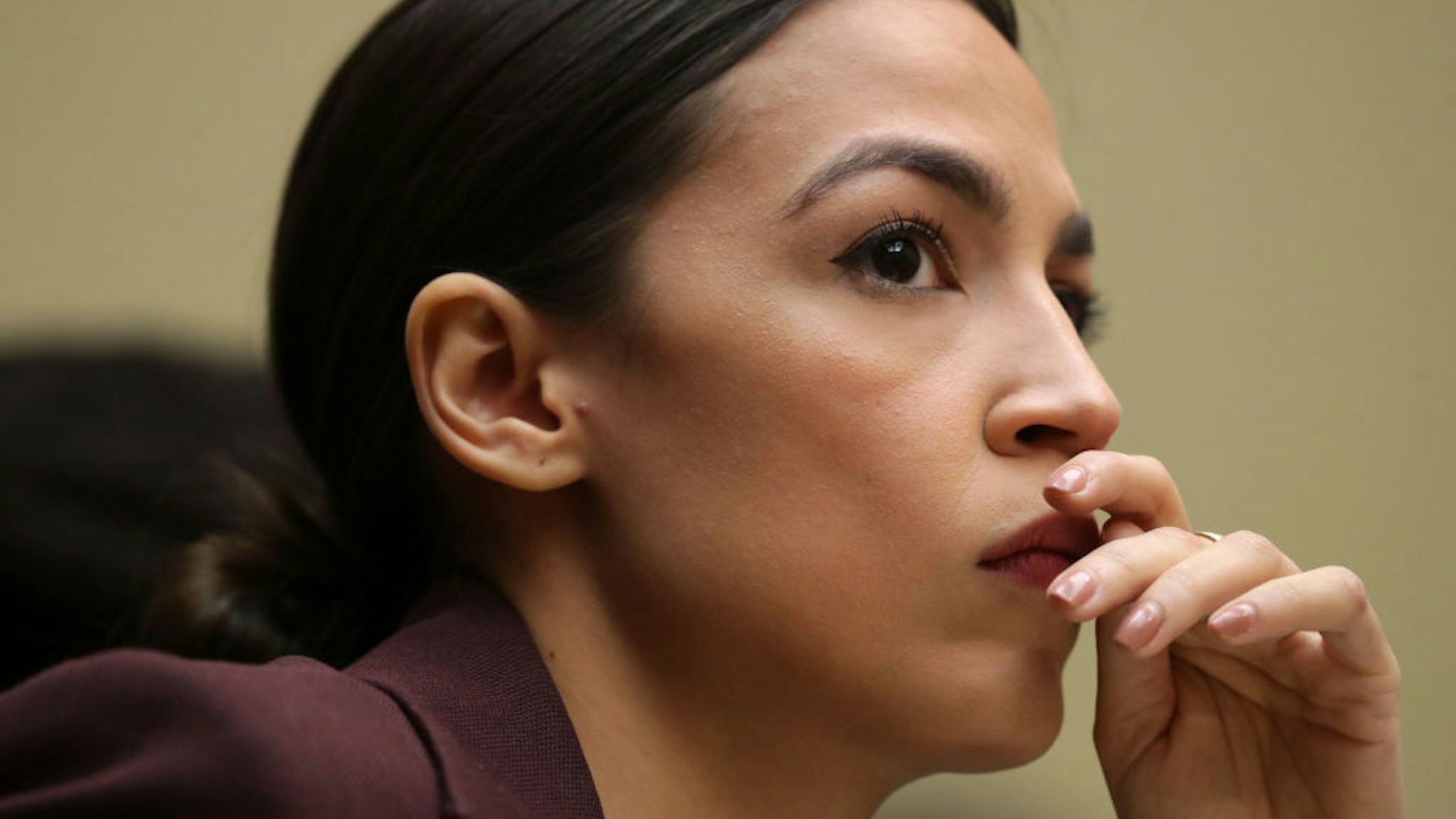 WASHINGTON, DC - FEBRUARY 27: Rep. Alexandria Ocasio-Cortez (D-NY) listens to testimony by Michael Cohen, former attorney and fixer for President Donald Trump, before the House Oversight Committee on Capitol Hill February 27, 2019 in Washington, DC. Last year Cohen was sentenced to three years in prison and ordered to pay a $50,000 fine for tax evasion, making false statements to a financial institution, unlawful excessive campaign contributions and lying to Congress as part of special counsel Robert Mueller's investigation into Russian meddling in the 2016 presidential elections.