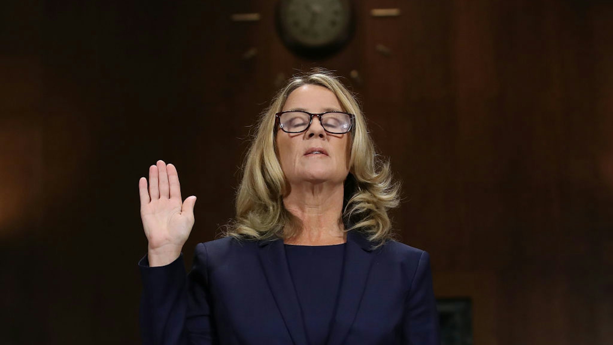 WASHINGTON, DC - SEPTEMBER 27: Christine Blasey Ford is sworn in before testifying the Senate Judiciary Committee in the Dirksen Senate Office Building on Capitol Hill September 27, 2018 in Washington, DC.