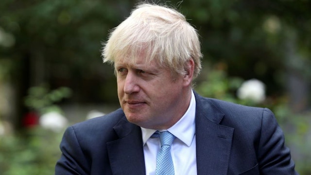 Britain's Prime Minister Boris Johnson looks on as he speaks with British actress Barbara Windsor (not pictured) after she delivers a petition calling for urgent action on dementia care in the garden at 10 Downing Street on September 2, 2019.