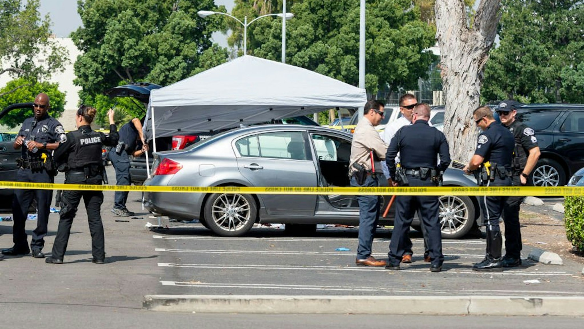 Police investigate a car where a retired Cal State Fullerton administrator was stabbed to death Monday, August 19, 2019 in Fullerton, CA.