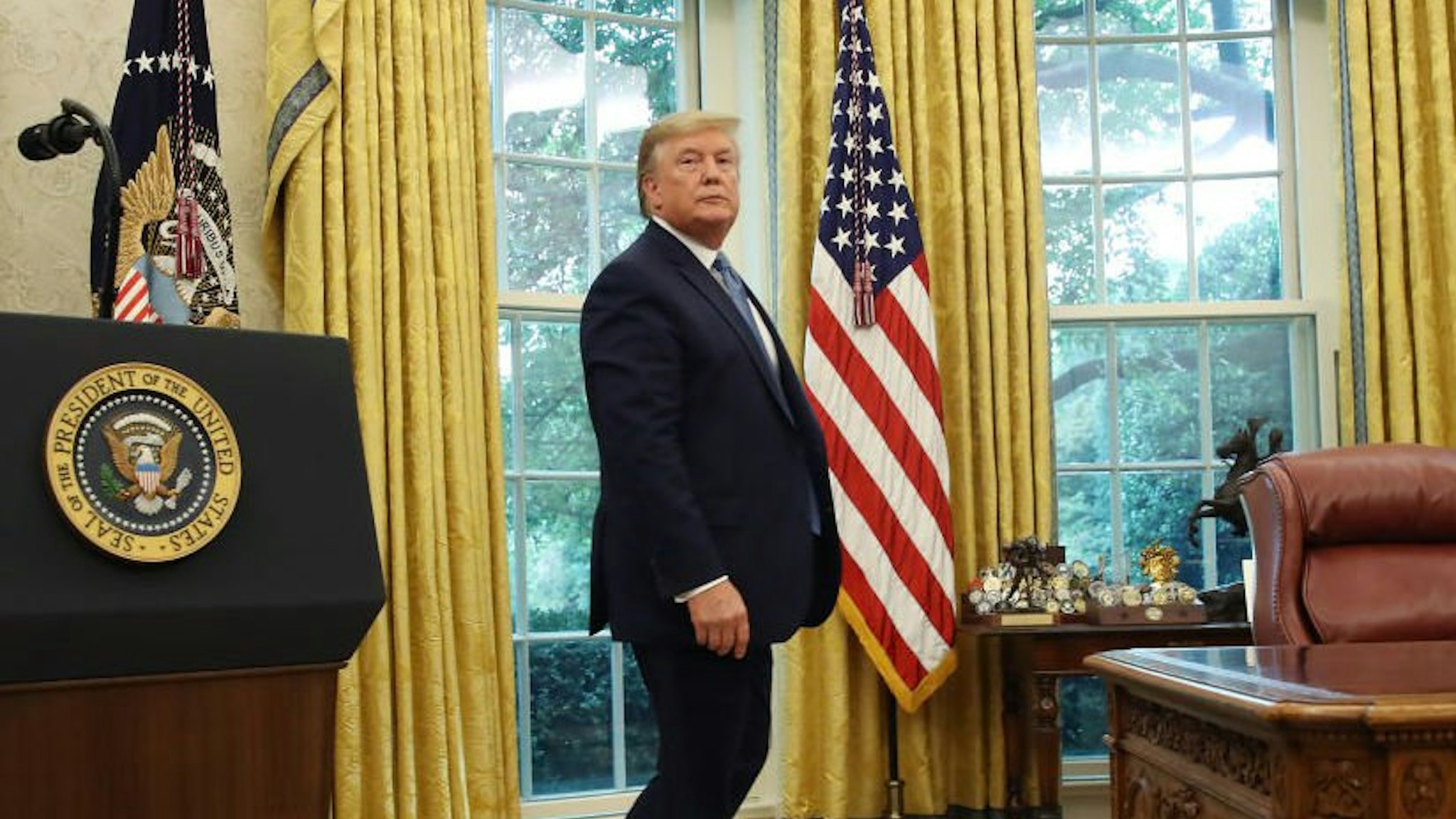 U.S. President Donald Trump walks away after presenting the Medal of Freedom to retired Boston Celtic Bob Cousy in the Oval Office at the White House on August 22, 2019 in Washington, DC.