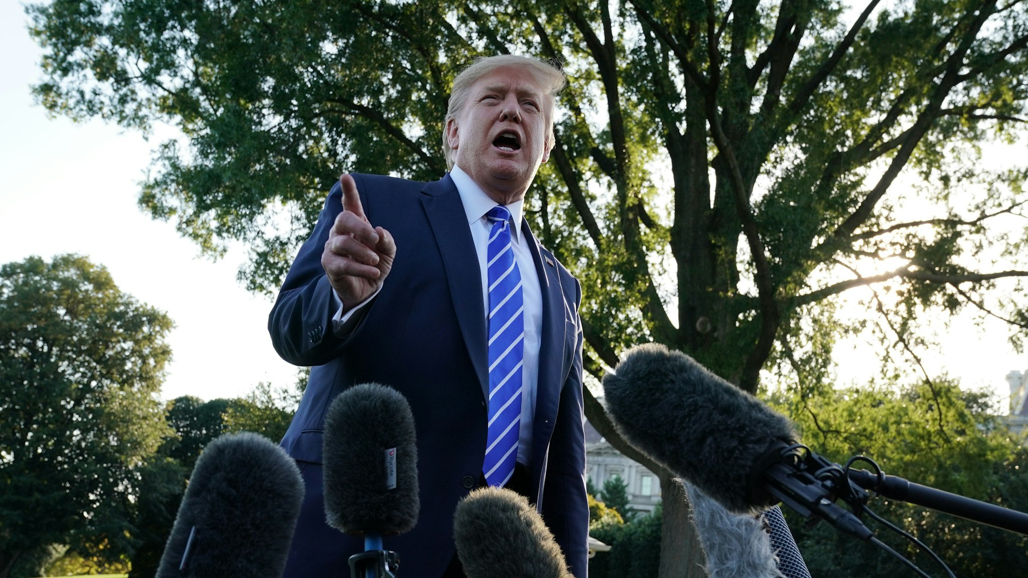 U.S. President Donald Trump speaks to members of the media prior to his departure for Camp David August 30, 2019 at the White House in Washington, DC.