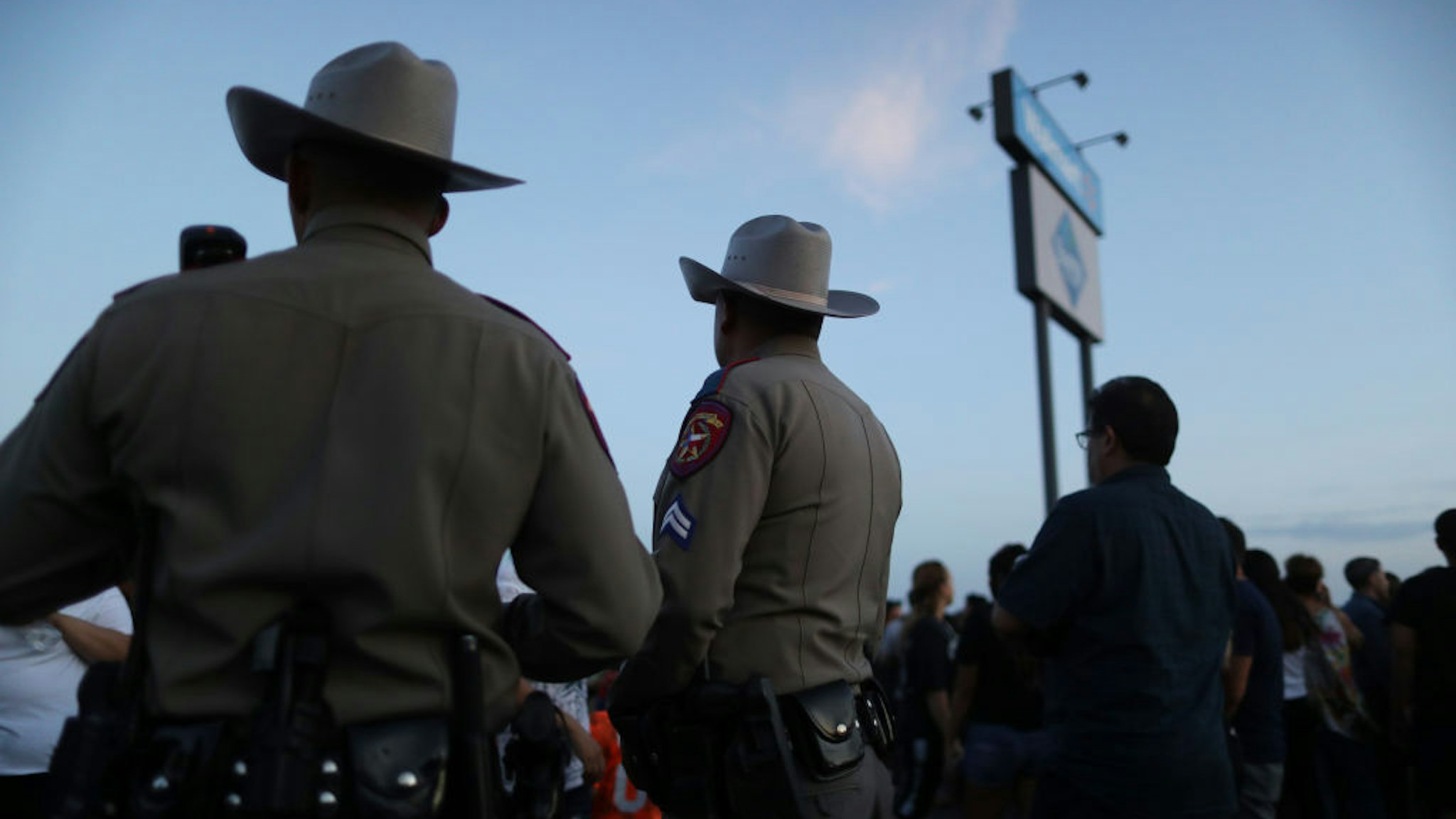Police keep watch at a makeshift memorial honoring victims outside Walmart, near the scene of a mass shooting which left at least 22 people dead, on August 6, 2019 in El Paso, Texas.