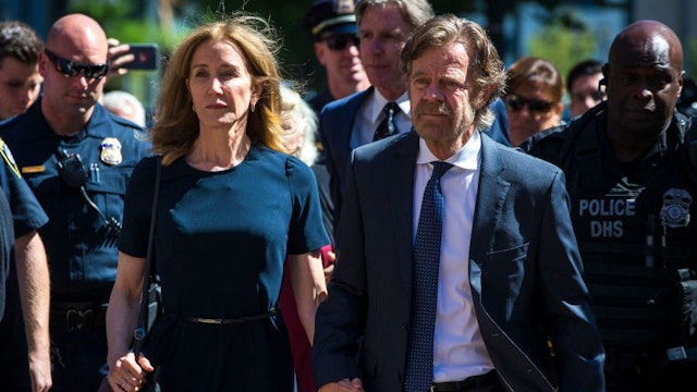 Felicity Huffman arrives with her husband William H. Macy at John Joseph Moakley US Courthouse in Boston on Sept. 13, 2019.