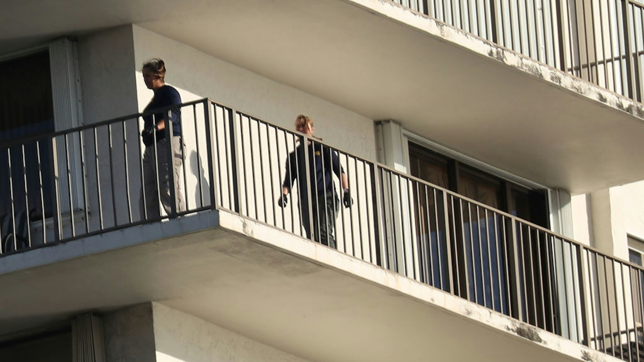 AVENTURA, FL - OCTOBER 26: FBI Agents walk on along the balcony of a condo in the building that has a possible connection to alleged bomber Cesar Sayoc and his mother on October 26, 2018 in Aventura, Florida. Mr. Sayoc was arrested today on allegations that he was the person that mailed pipe bomb devices that targeted critics of President Donald Trump and have been recovered in New York, Washington D.C., California and South Florida, all with the return address of Debbie Wassermann-Schultz's office.