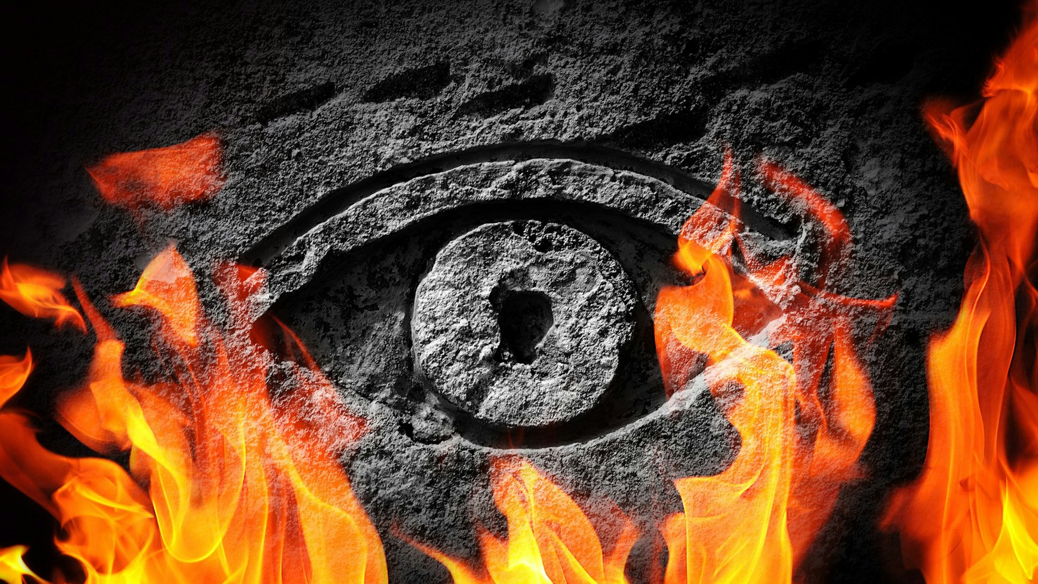 A stone eye engulfed in flames