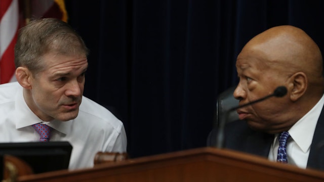 U.S. Rep. Jim Jordan (R-OH) (L) talks with House Oversight and Reform Committee Chairman Elijah Cummings (D-MD) during a hearing on March 14, 2019 in Washington, DC.