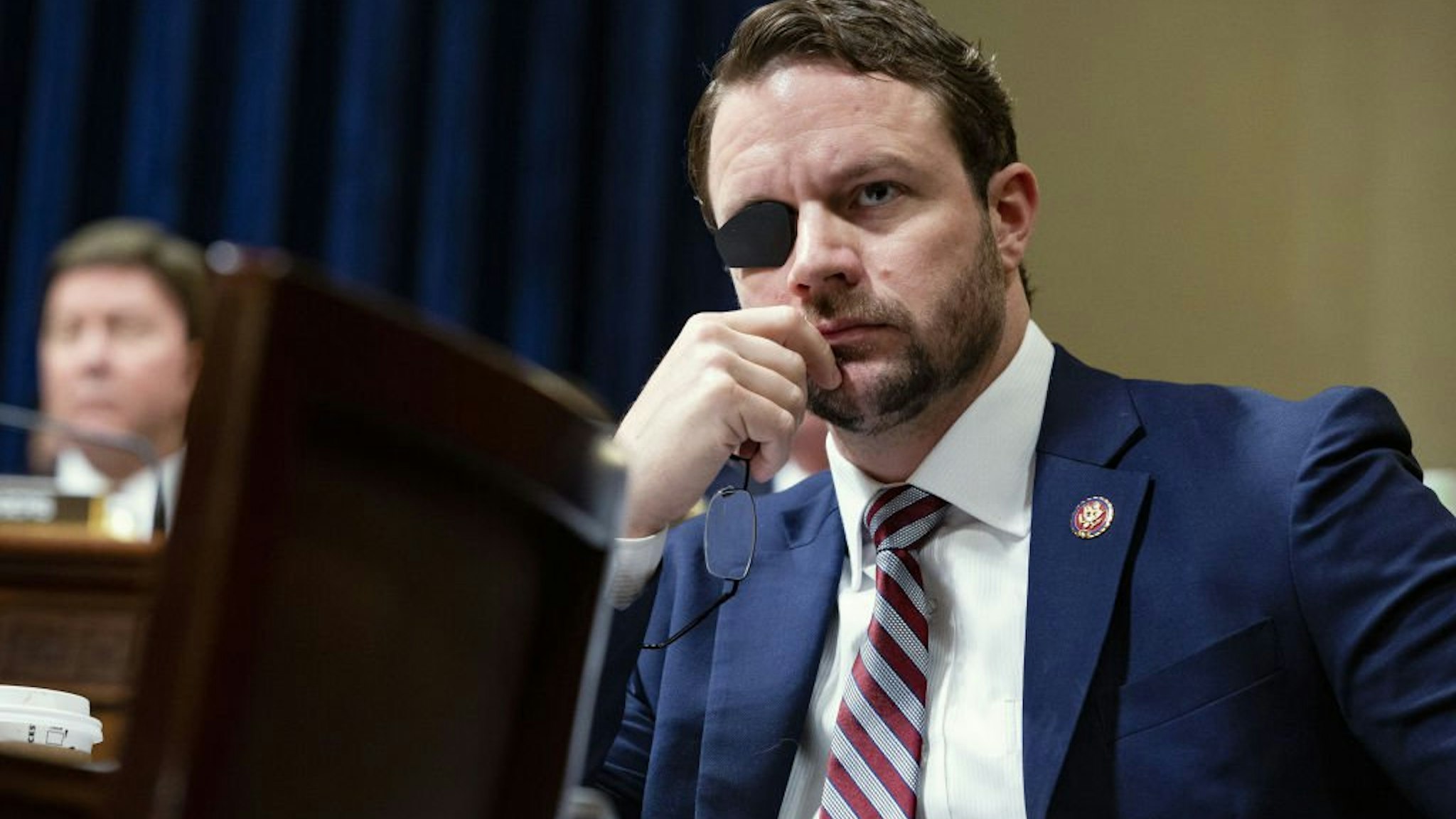 Representative Dan Crenshaw, a Republican from Texas, listens during a House Homeland Security Committee hearing in Washington, D.C., U.S., on Wednesday, June 26, 2019.