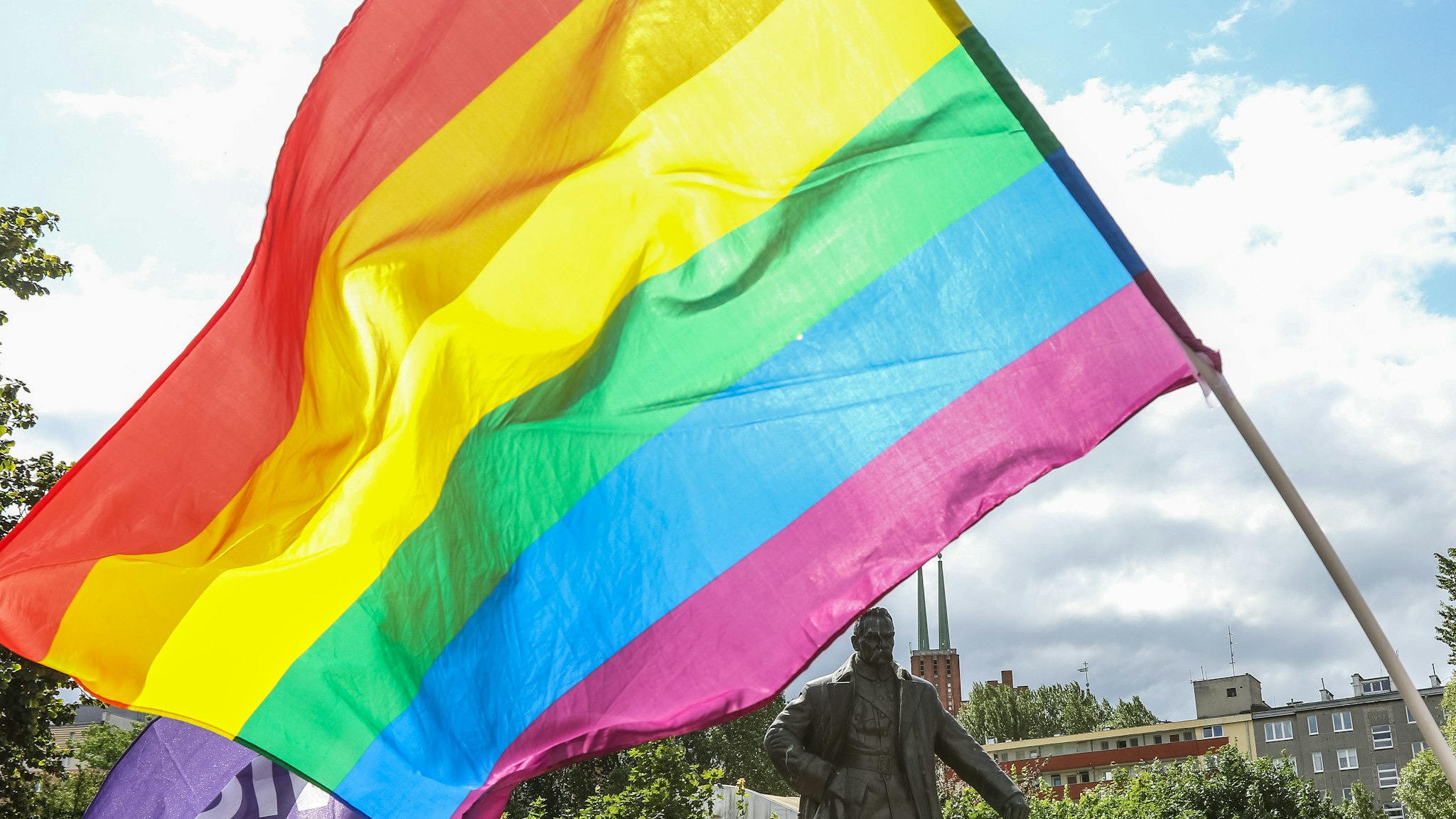 The Equality March (Marsz Rownych) participants holding the rainbow flag in front of Jozef Pilsudski monument are seen in Gdynia, Poland on 7 July 2019 Second Equality March in Gdynia is organised to support LGBTQ
