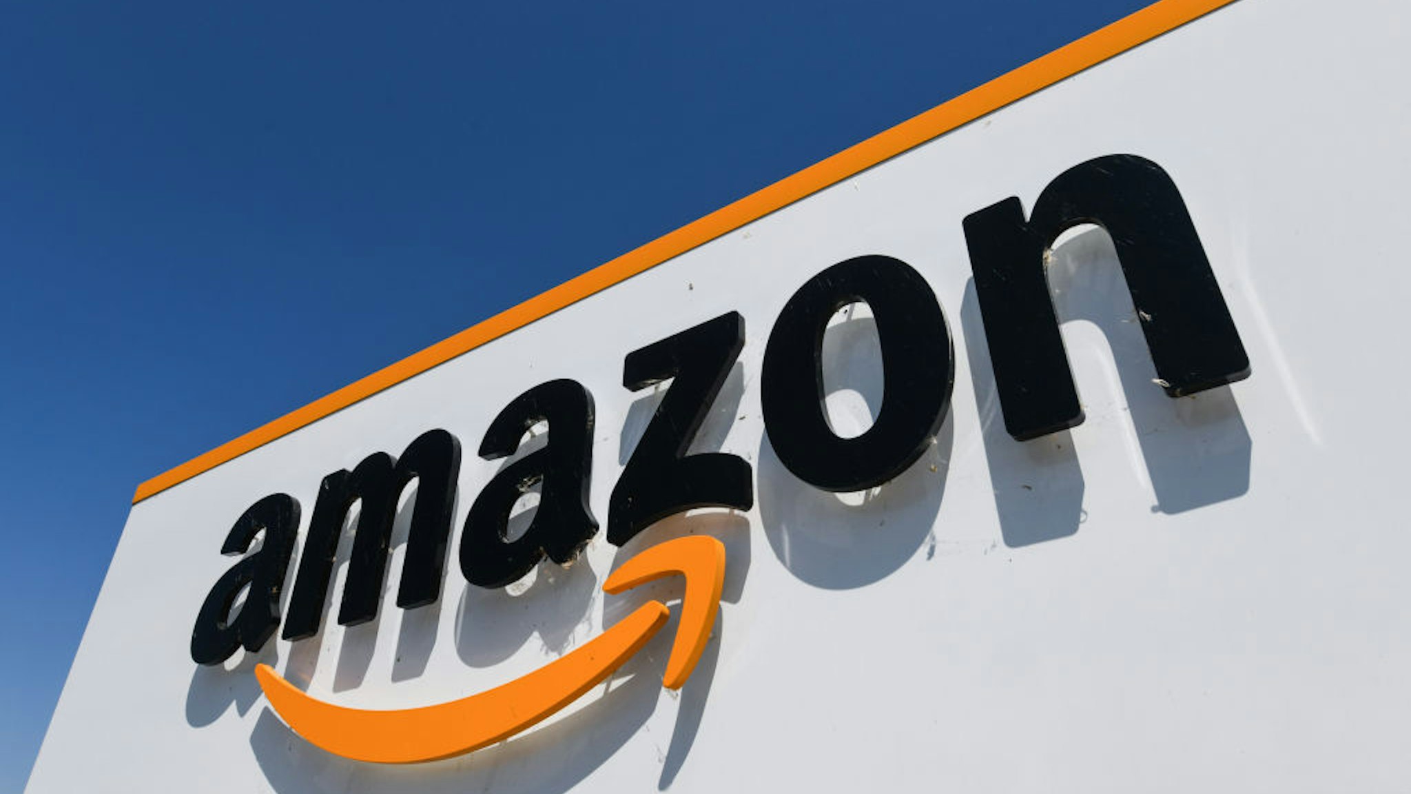 A picture shows the Amazon logo at the entrance of the Amazon logistics centre in Amiens, northern France, on July 23, 2019.