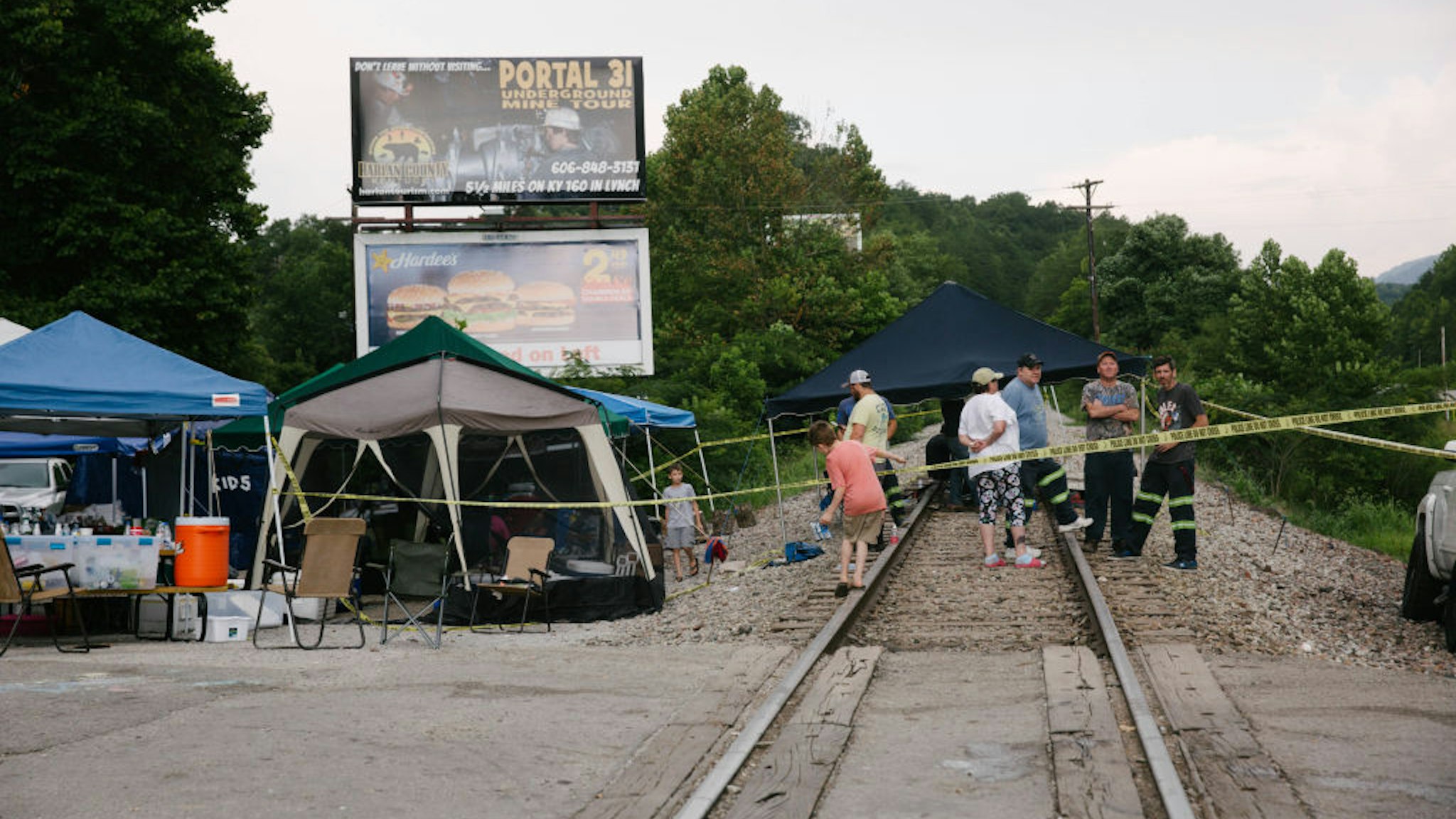 Supporters of miners stand on train tracks in Cumberland, Kentucky, U.S., on Friday, Aug. 2, 2019. The miners have been working in shifts to block railroad tracks leading to a Blackjewel mine outside since Monday afternoon, Harlan County Judge-Executive Dan Mosley said in an interview. They're demanding back pay for work done in weeks leading up to the bankruptcy, after checks issued by Blackjewel bounced or never arrived. Photographer: Meg Roussos/Bloomberg via Getty Images