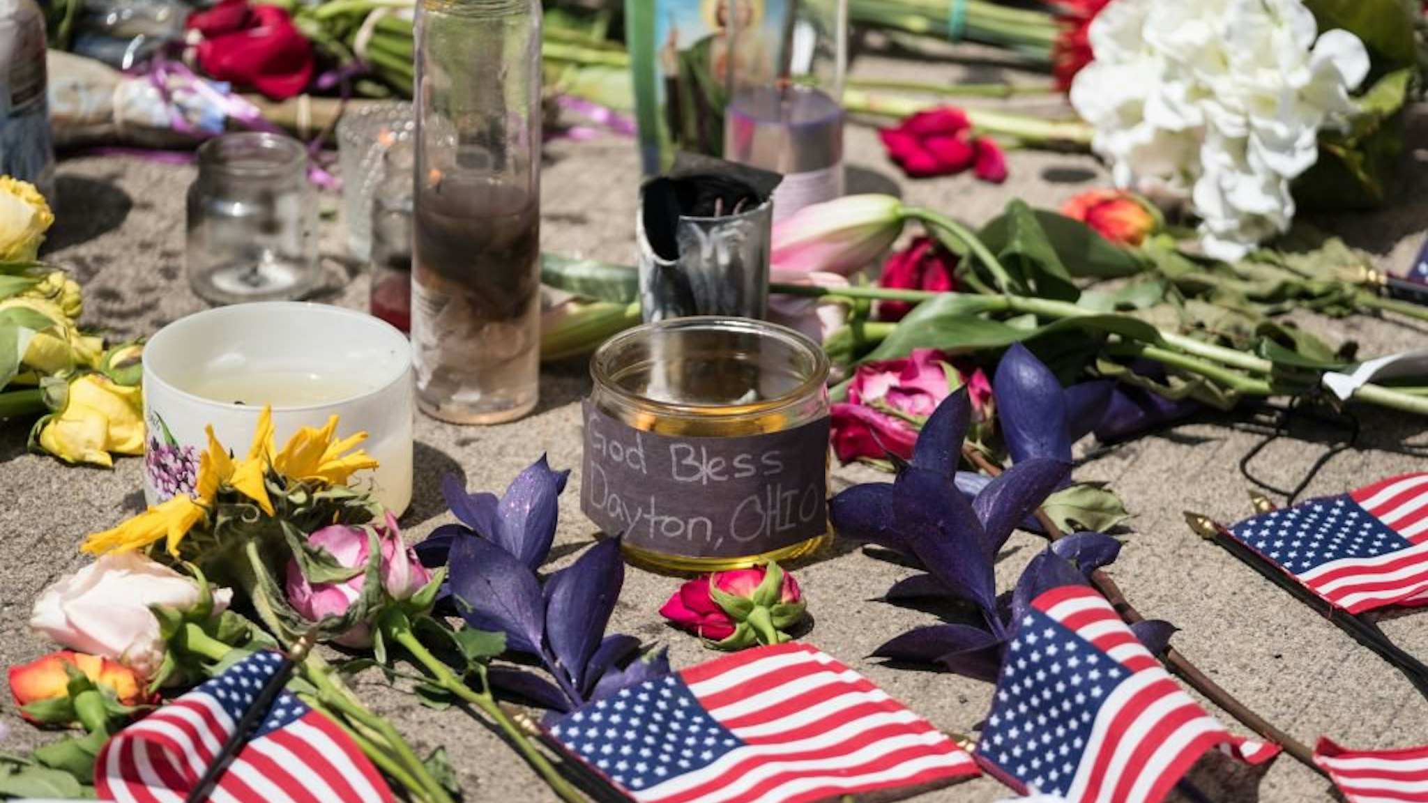 Candles and flowers a placed in front of Ned Peppers bar after the mass shooting over the weekend in Dayton, Ohio on August 5, 2019. - US President Donald Trump urged Republicans and Democrats to agree on tighter gun control and suggested legislation coul