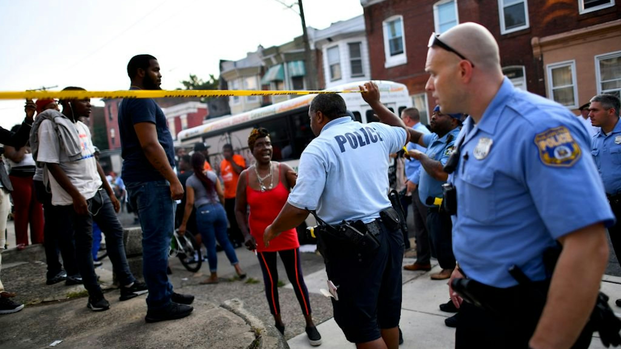 Police officers direct citizens to move back near the scene of a shooting on August 14, 2019 in Philadelphia, Pennsylvania. At least six police officers were reportedly wounded in an hours-long standoff with a gunman that prompted a massive law enforcemen
