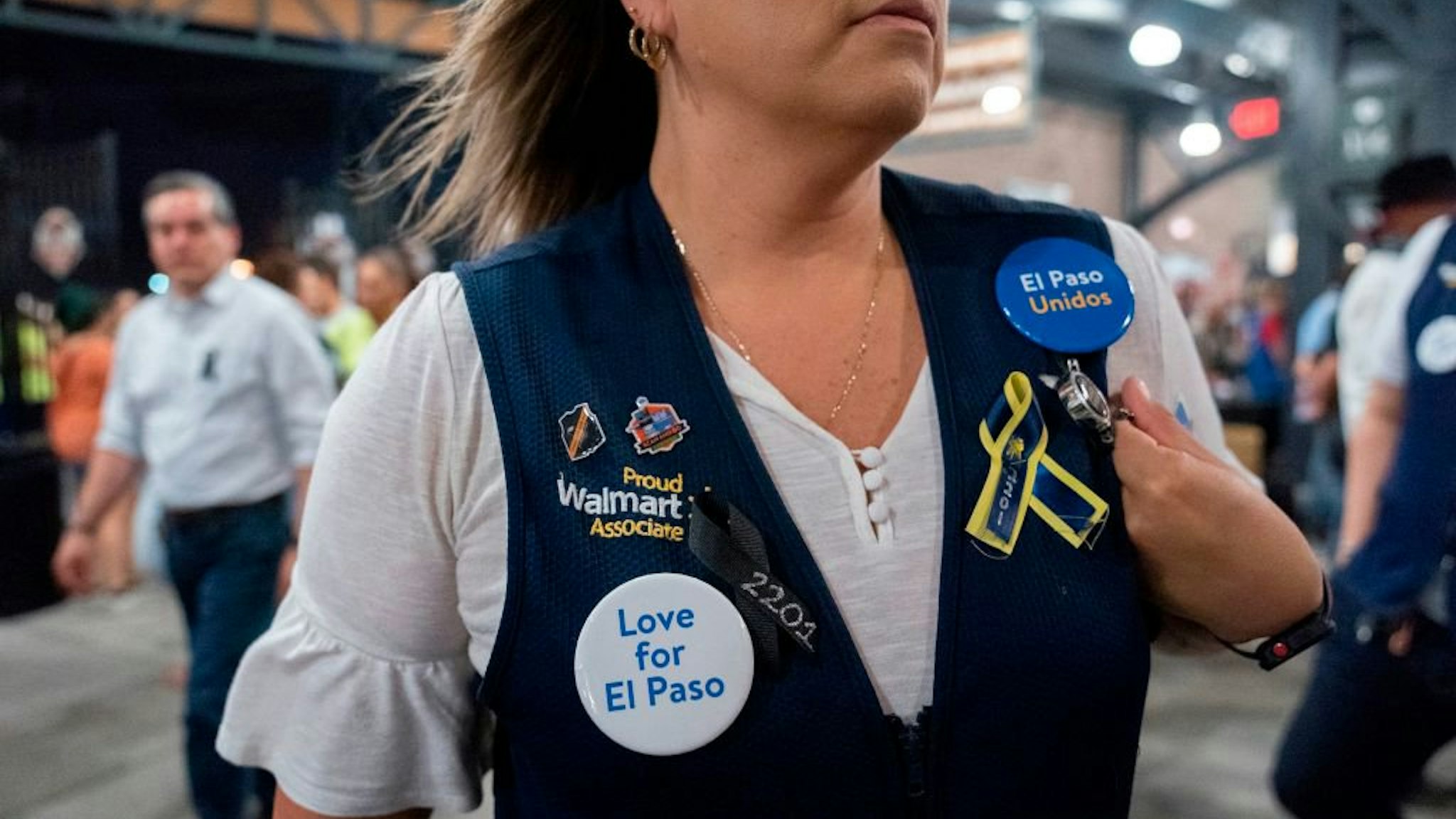 A Walmart employee attends a community memorial service for the 22 victims of the mass shooting at Southwest University Park in El Paso, Texas on August 14, 2019.