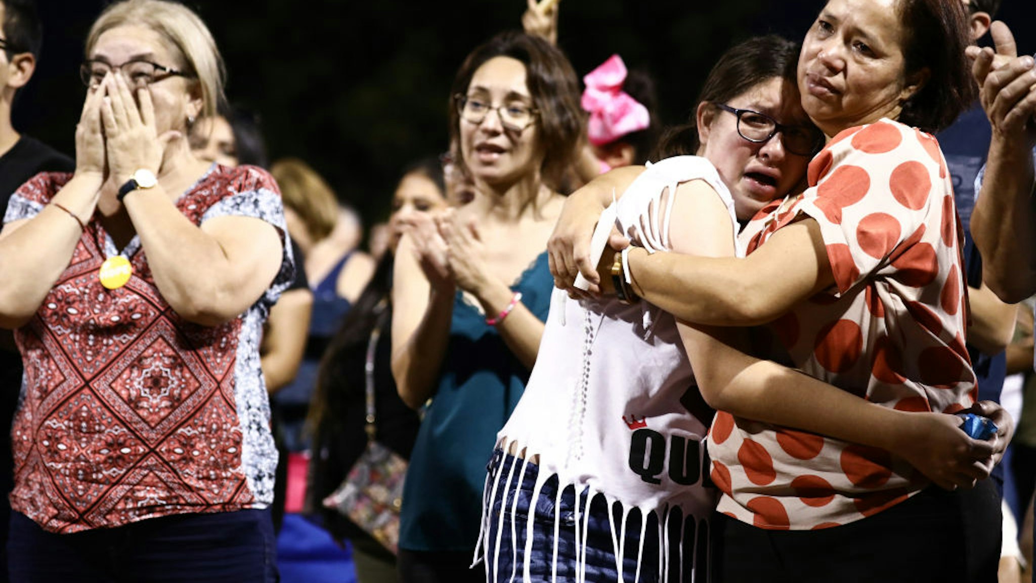 EL PASO, TEXAS - AUGUST 04: People react and embrace each other during an interfaith vigil for victims of a mass shooting which left at least 20 people dead, on August 4, 2019 in El Paso, Texas. A 21-year-old male suspect was taken into custody in the city which sits along the U.S.-Mexico border. At least 26 people were wounded.