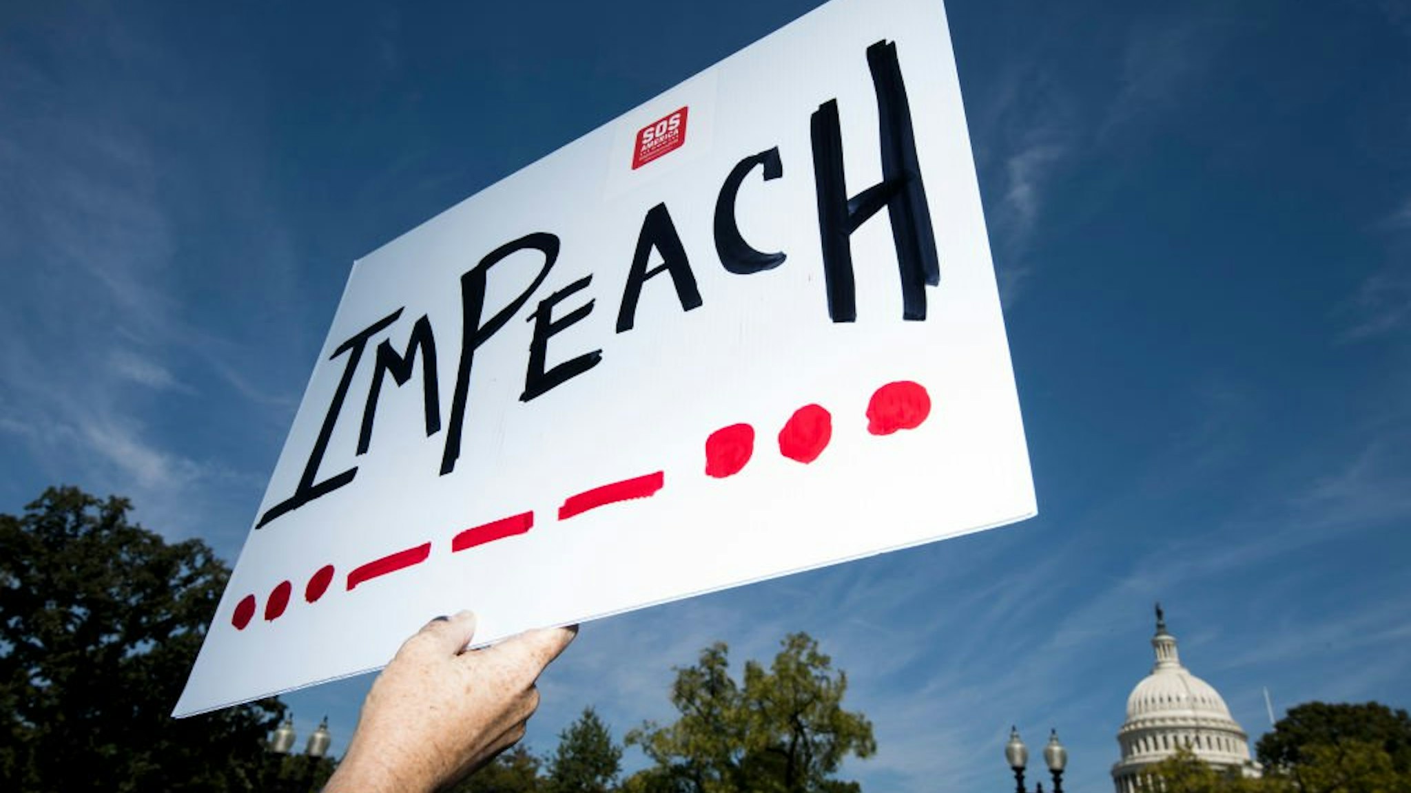 An "Impeach" protest sign