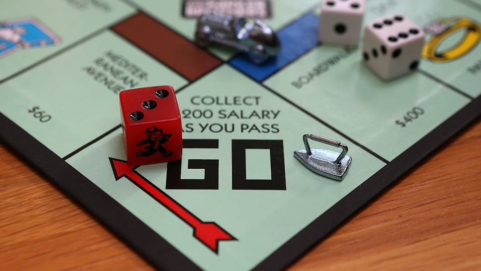 Monopoly Board Game FAIRFAX, CA - FEBRUARY 06: In this photo illustration, the Monopoly iron game piece is displayed on February 6, 2013 in Fairfax, California. Toy maker Hasbro, Inc. announced today that fans of the board game Monopoly voted in an online contest to eliminate the iron playing figure and replace it with a cat figure. The cat game piece received 31 percent of the online votes to beat out four other contenders, a robot, diamond ring, helicopter and guitar.