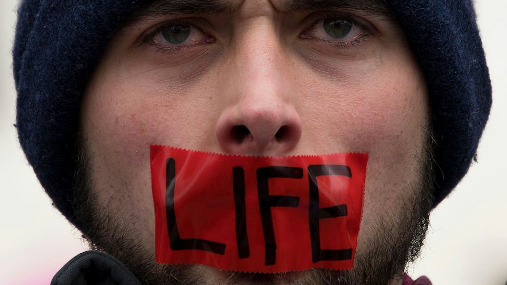 A man wears tape over his mouth during protests at the 44th annual March for Life on January 27, 2017 in Washington, DC. Anti-abortion activists are gathering for the 44th annual March for Life in Washington, protesting the 1973 Supreme Court decision leg