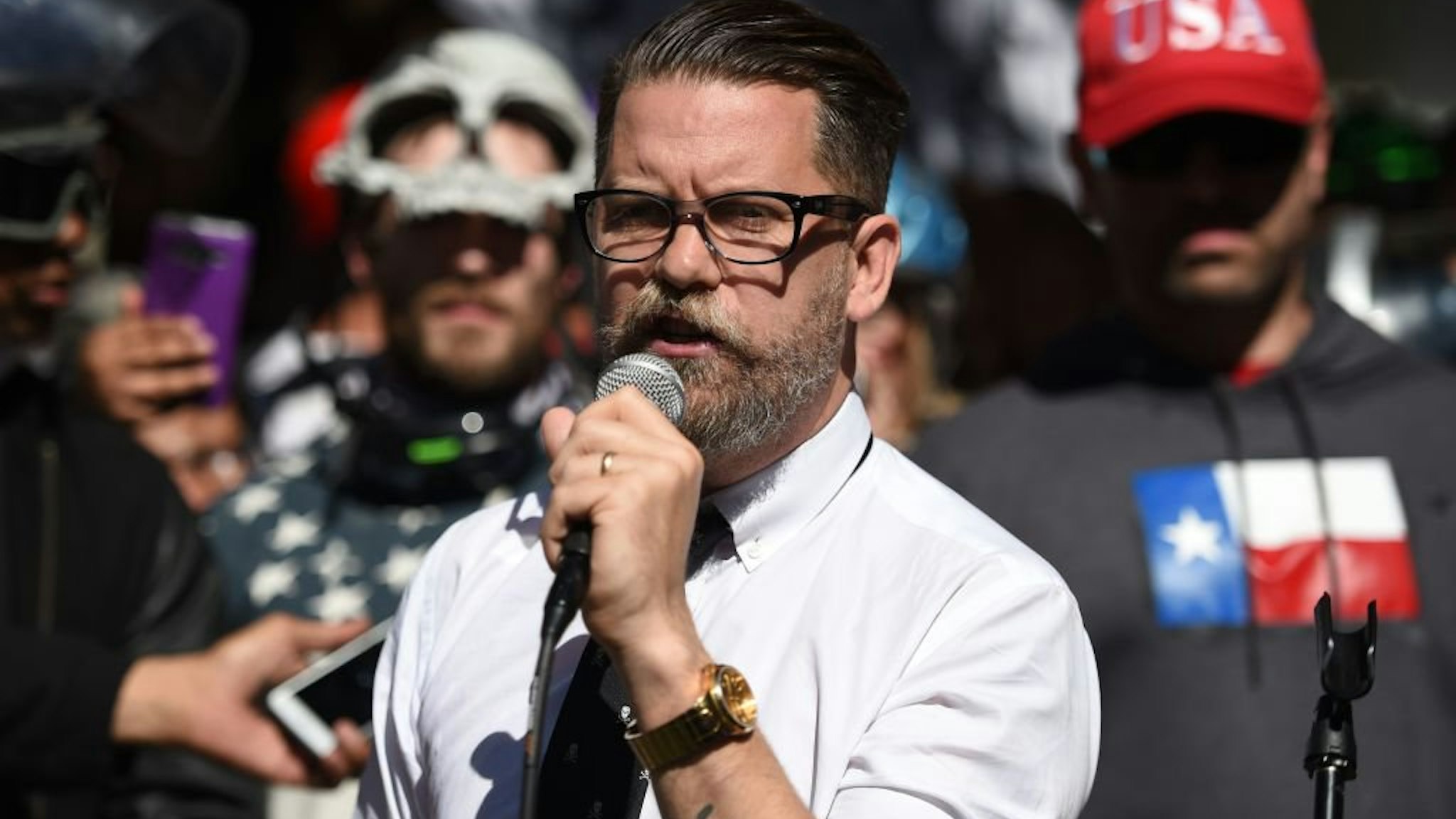Vice Media co-founder and conservative speaker Gavin McInnes reads a speech written by Ann Coulter to a crowd during a conservative rally in Berkeley, California on April 27, 2017. Conservative firebrand Ann Coulter on April 26, 2017 canceled a planned ap