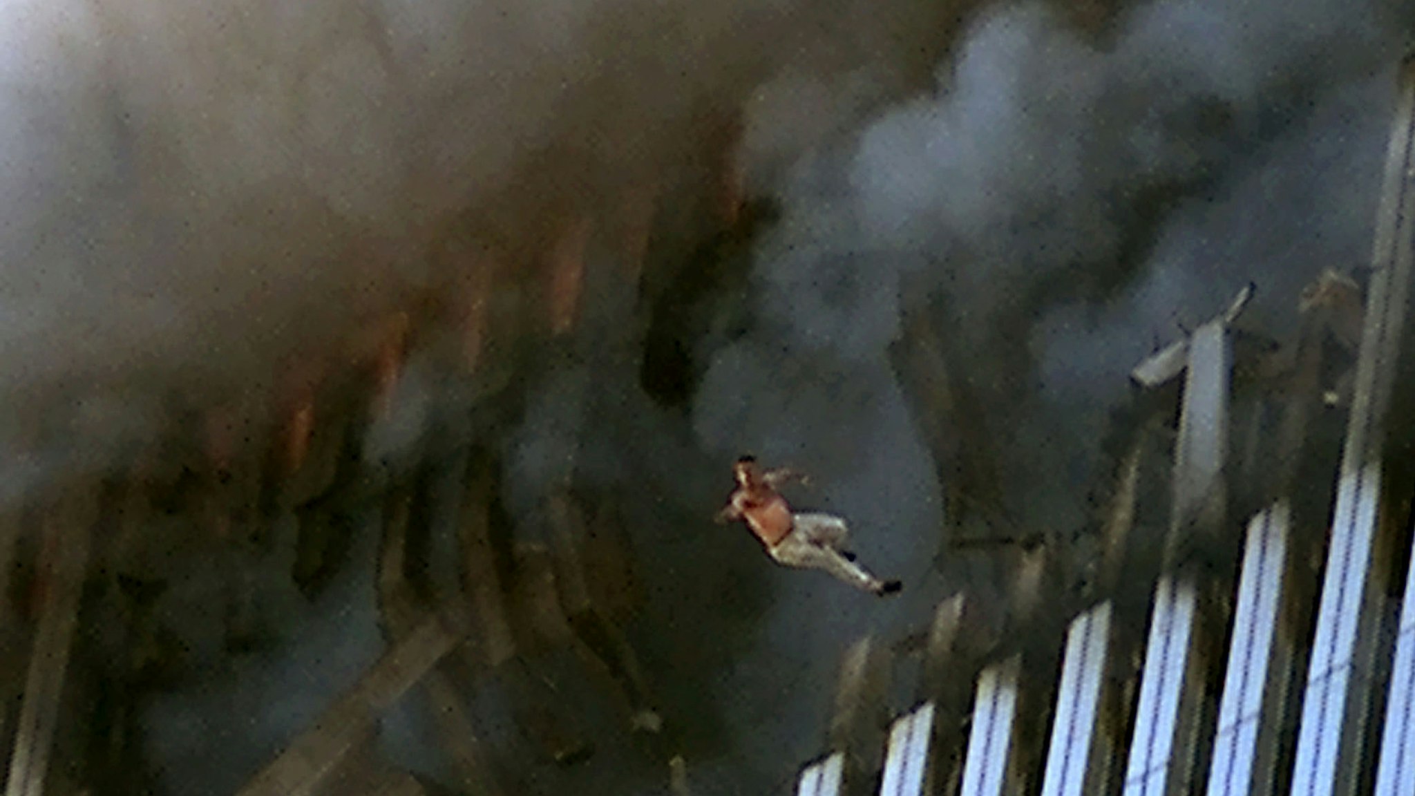 A man leaps to his death from a fire and smoke filled Tower One of the World Trade Center September 11, 2001 in New York City after terrorists crashed two hijacked passenger planes into the twin towers.