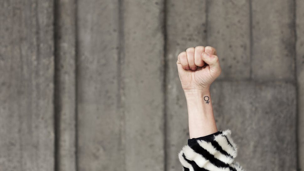 Woman Holding Up Fist Woman Holding Up Fist