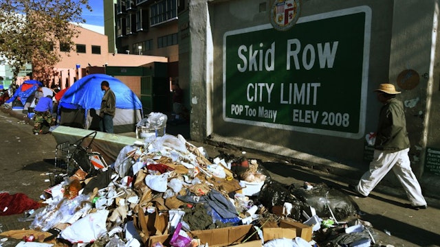 Trash lies beside the Skid Row City Limit mural as the city begins its annual homeless count in Los Angeles, California on January 26, 2018. Thousnads of volunteers will fan out across Los Angeles County during the three-night count of homeless people whose population is estimated to be nearly 60,000 strong.