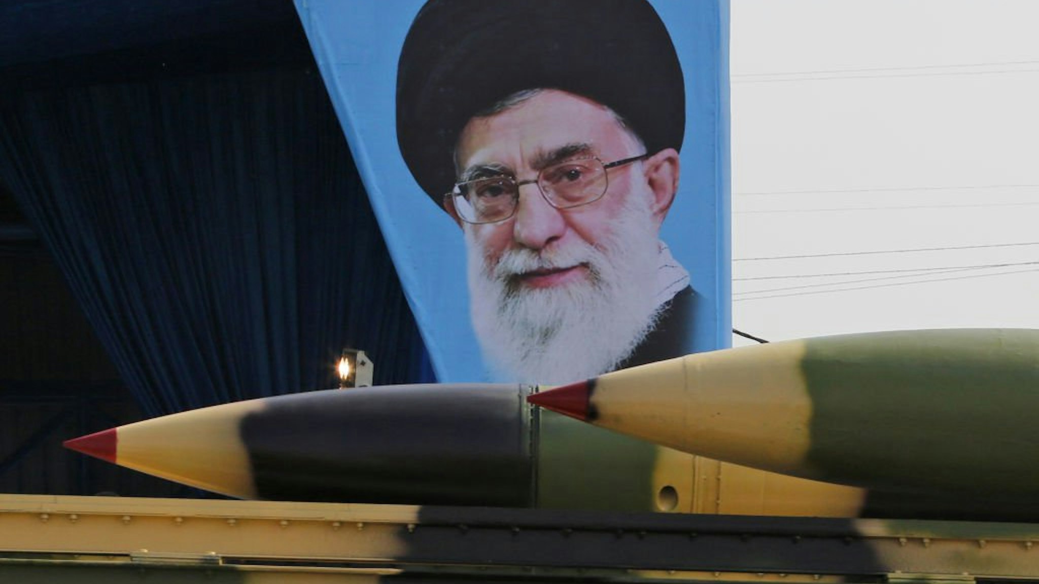 Rouhani's photo set behind image of weapons in Iran