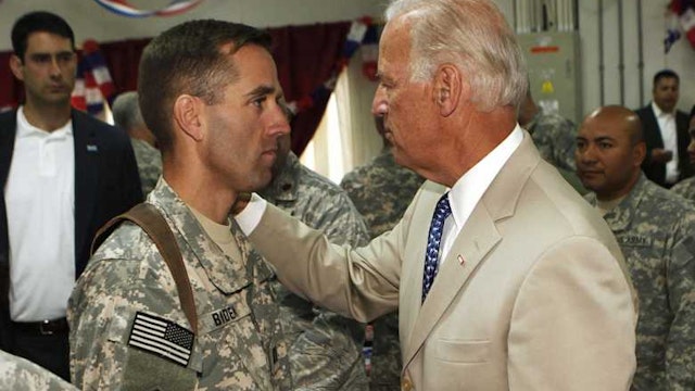 U.S. Vice President Joe Biden (R) talks with his son, U.S. Army Capt. Beau Biden (L) at Camp Victory on the outskirts of Baghdad on July 4, 2009