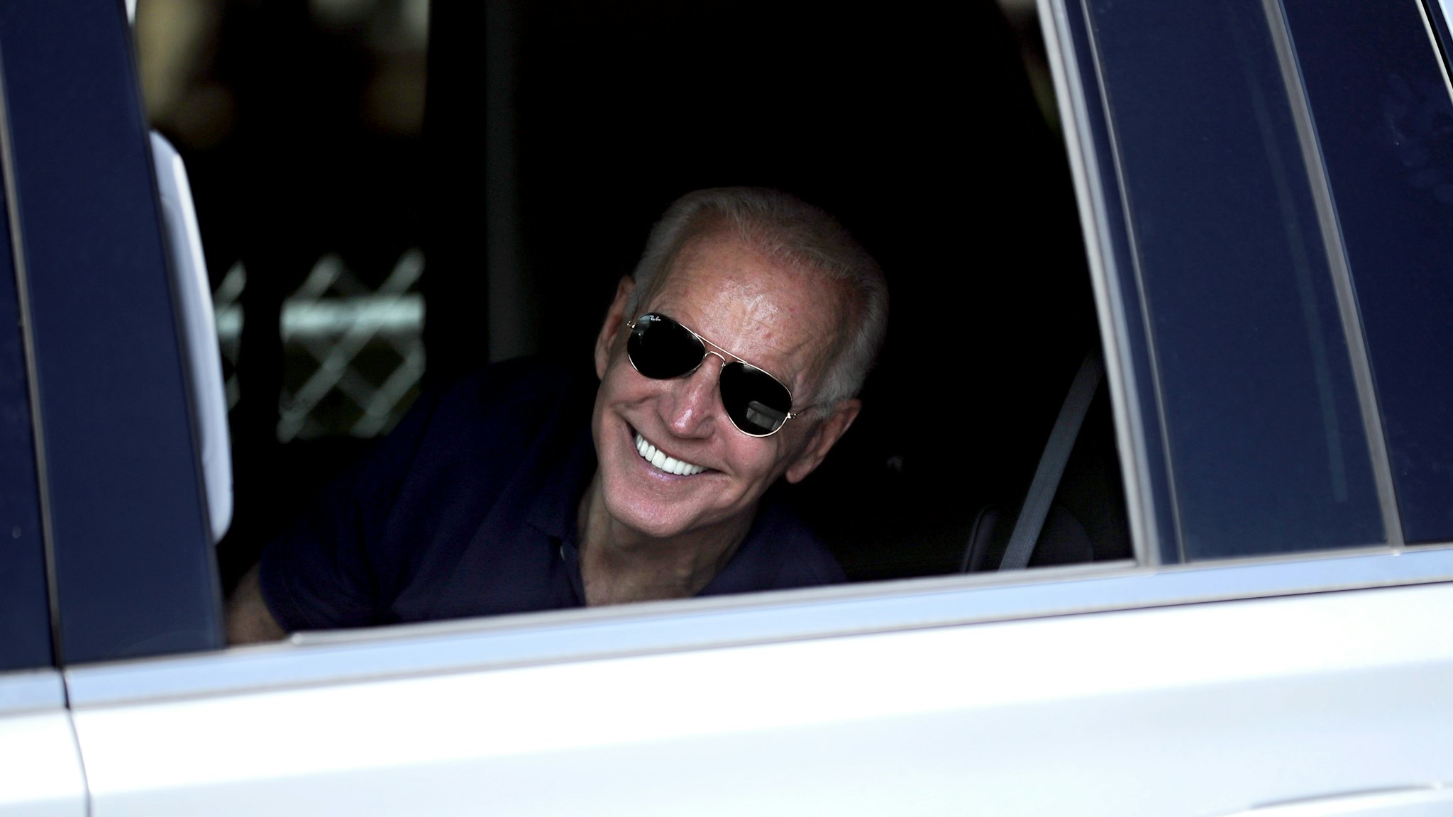 DES MOINES, IOWA - AUGUST 08: Democratic presidential candidate and former Vice President Joe Biden rolls down the window of his truck to say goodbye to supporters as he leaves the Iowa State Fair August 08, 2019 in Des Moines, Iowa. 22 of the 23 politicians seeking the Democratic Party presidential nomination will be visiting the fair this week, six months ahead of the all-important Iowa caucuses.