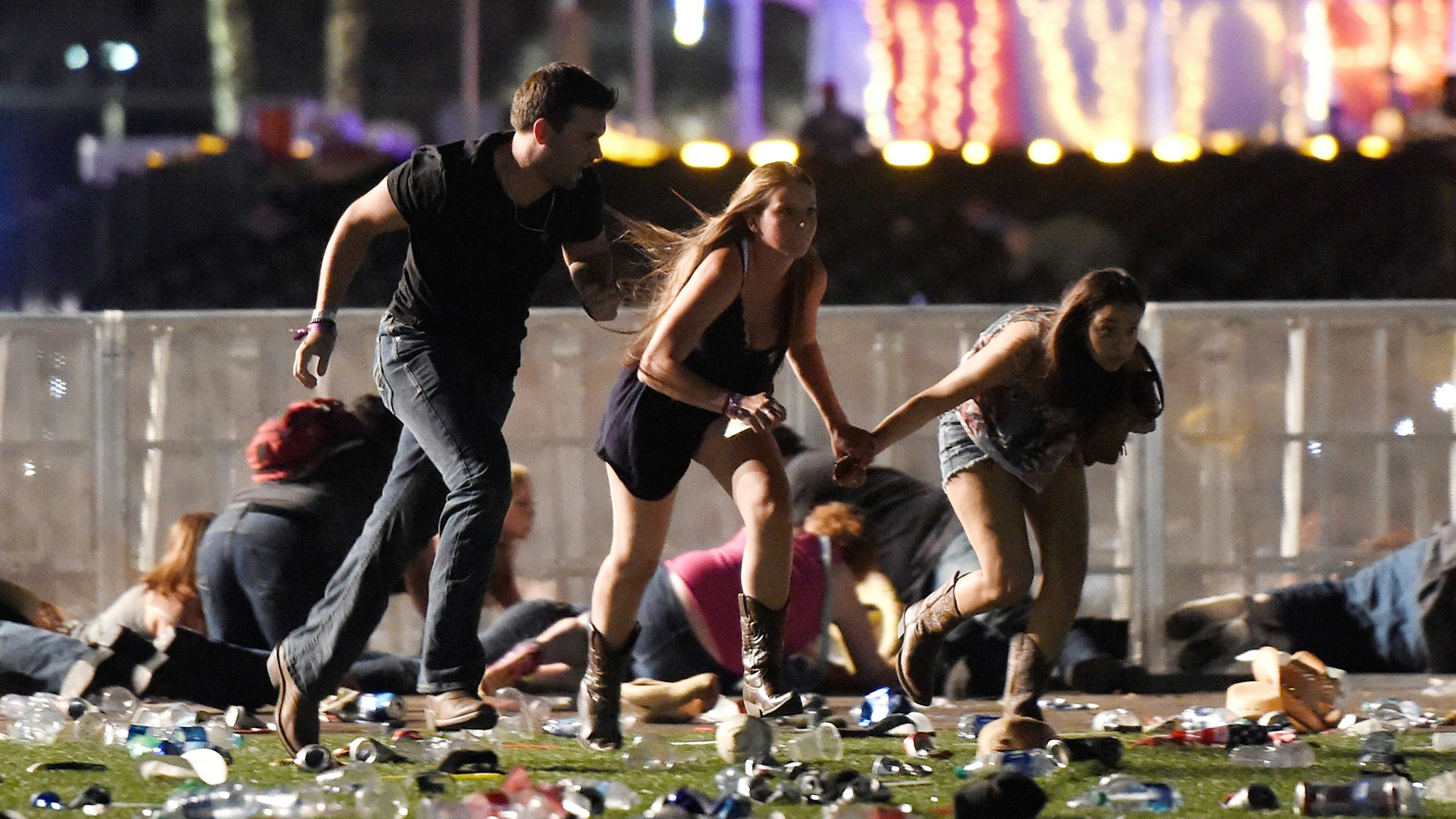 LAS VEGAS, NV - OCTOBER 01: People run from the Route 91 Harvest country music festival after apparent gun fire was hear on October 1, 2017 in Las Vegas, Nevada. A gunman has opened fire on a music festival in Las Vegas, leaving at least 20 people dead and more than 100 injured. Police have confirmed that one suspect has been shot. The investigation is ongoing.