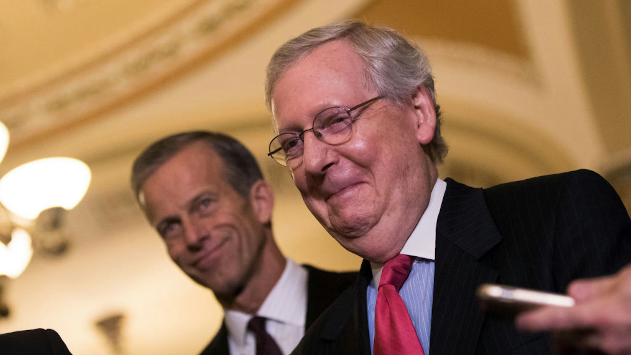 Mitch McConnell (R-KY) smiles after addressing reporters following a lunch with Senate Republicans.