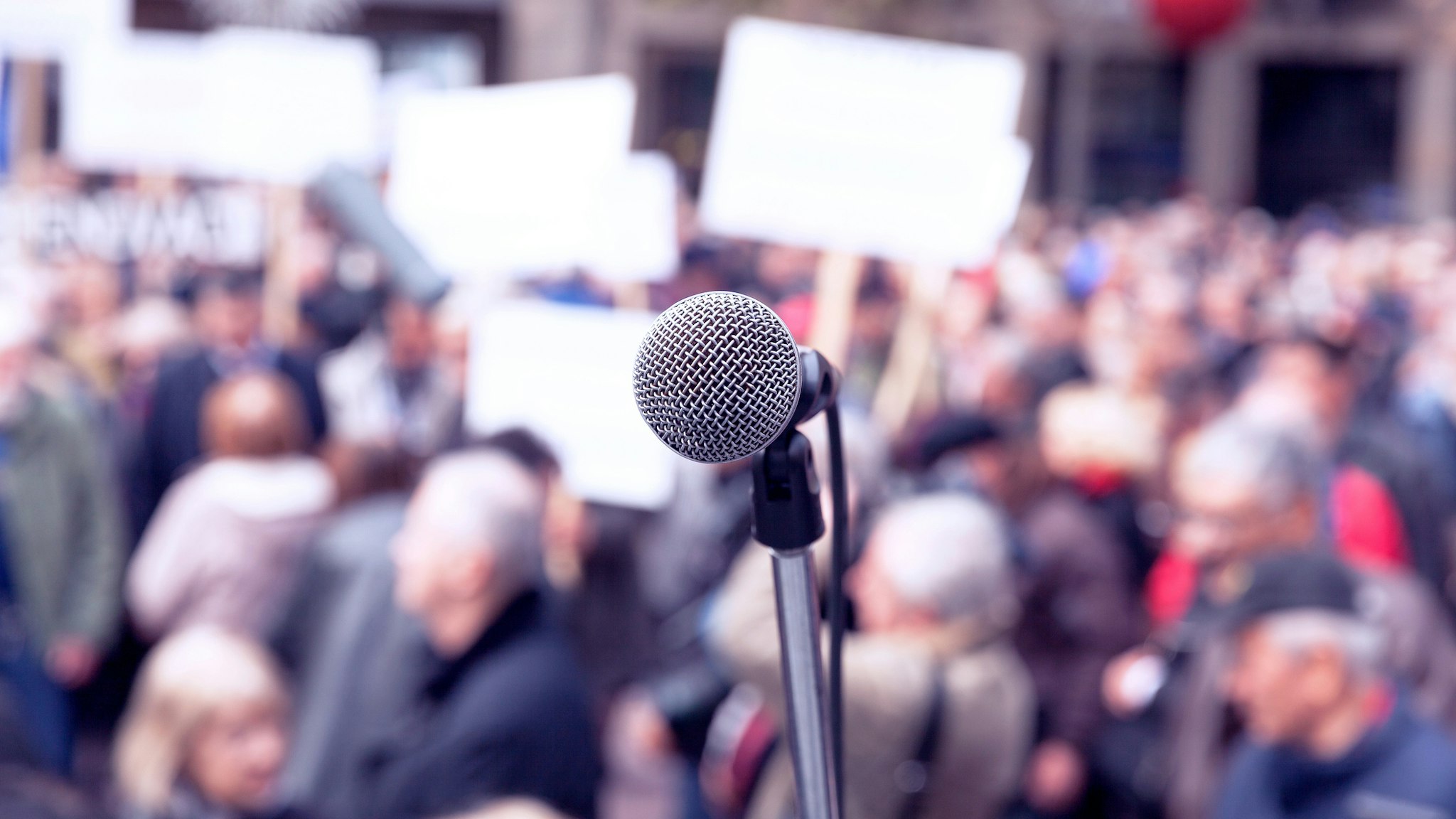 Microphone in focus against blurred protesters