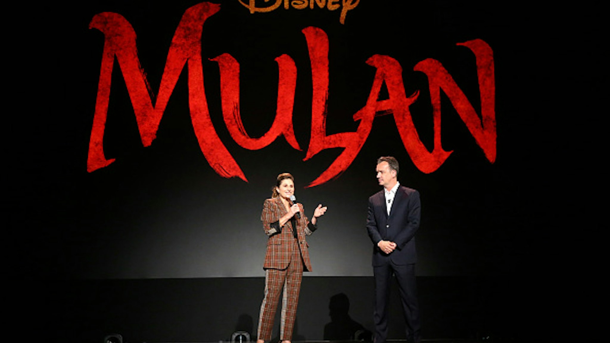 ANAHEIM, CALIFORNIA - AUGUST 24: (L-R) Director Niki Caro of 'Mulan' and President of Walt Disney Studios Motion Picture Production Sean Bailey took part today in the Walt Disney Studios presentation at Disney’s D23 EXPO 2019 in Anaheim, Calif. 'Mulan' will be released in U.S. theaters on March 27, 2020.