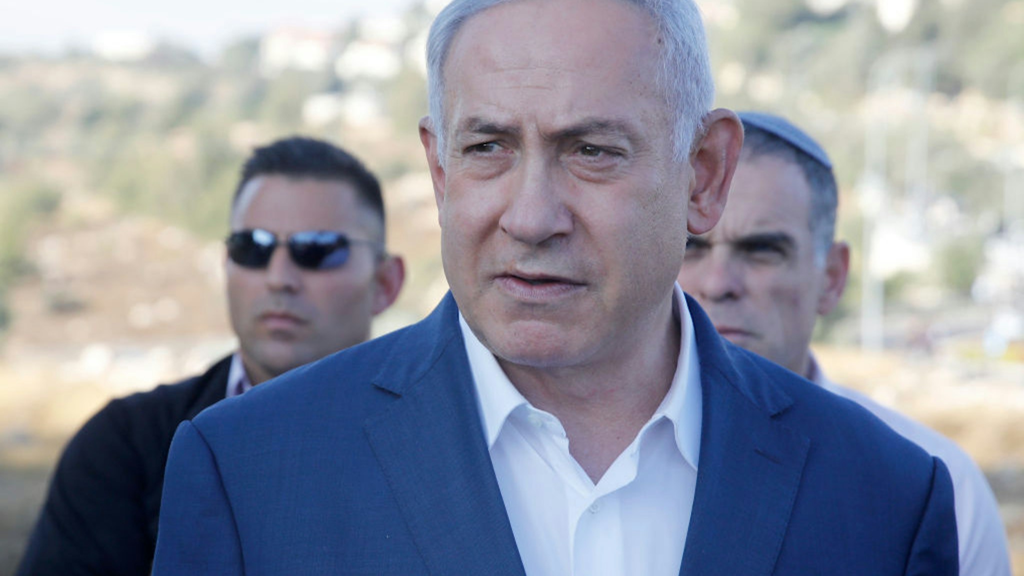 Israel's Prime Minister Benjamin Netanyahu speaks to the press at the site where an off-duty Israeli soldier was found dead