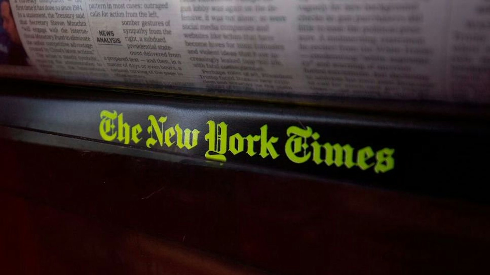 The New York Times logo is seen on a newspaper rack at a convenience store in Washington, DC, on August 6, 2019.