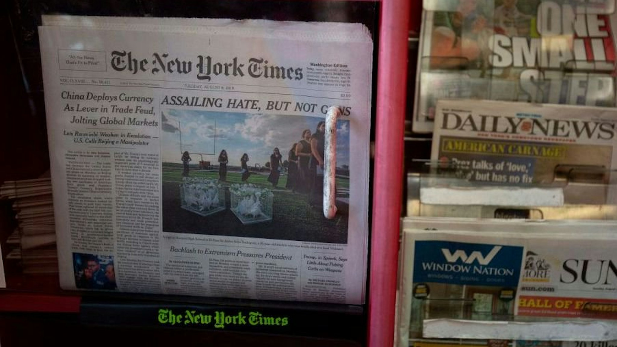 The front pages of The New York Times, New York Post, New York Daily News and Baltimore Sun newspapers are seen at a convenience store in Washington, DC, on August 6, 2019.